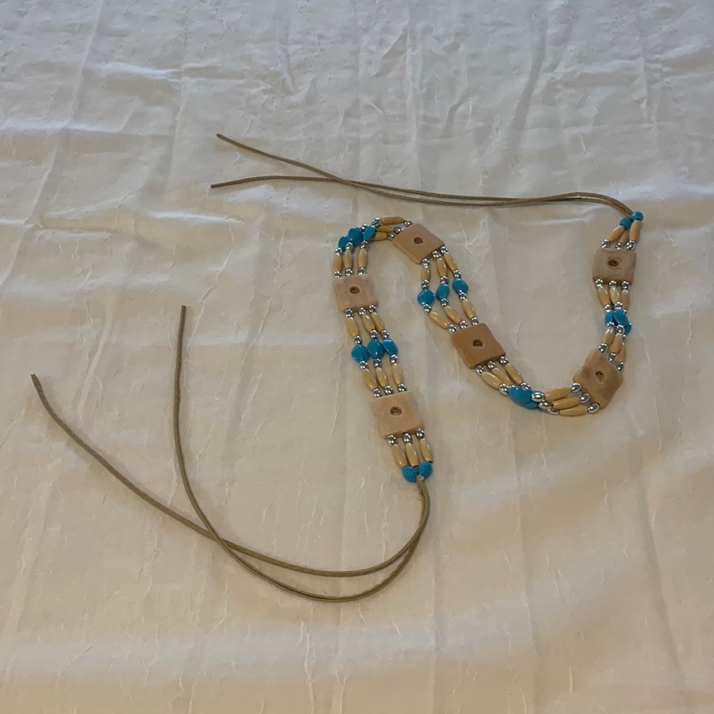 Wrap belt with beads and wood block beads and genuine leather ties.